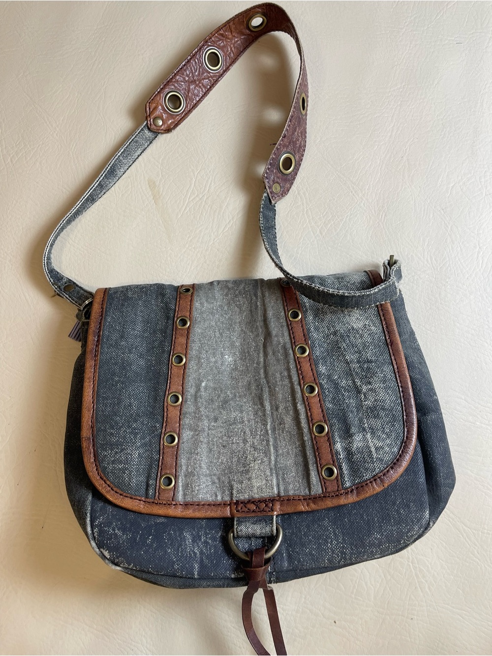 Mona B Denim-Style Crossbody with Brown Trim and Grommets